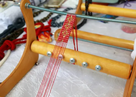 a wooden bead weaving loom