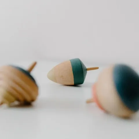 Three small tops laying on their sides.