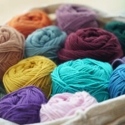 Bag filled with multiple skeins of yarn.