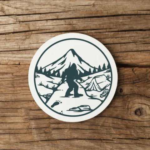 a white circular coaster featuring a sasquatch