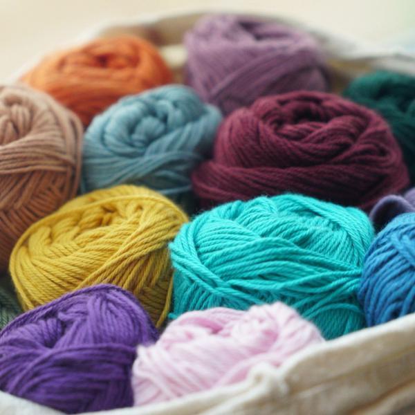 Bag filled with multiple skeins of yarn.