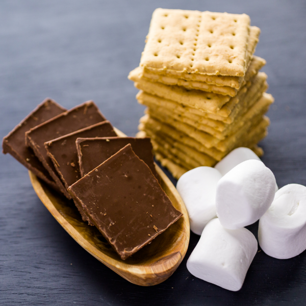 a pile of chocolate squares, graham crackers, and marshmallows